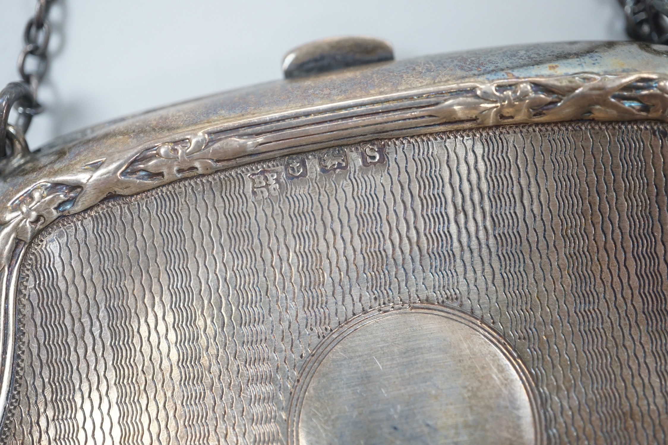 A George V engine turned silver purse, Boots Pure Drug Company, Birmingham, 1917 and a silver mounted nail buffer.